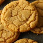 Close-up of chewy brown sugar cookies with crackled tops and a light sugar coating.