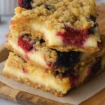 Golden crumb-topped bars filled with creamy cheesecake and juicy blueberries.