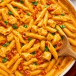 Creamy Marry Me Chicken Pasta with sun-dried tomatoes and herbs in a skillet.