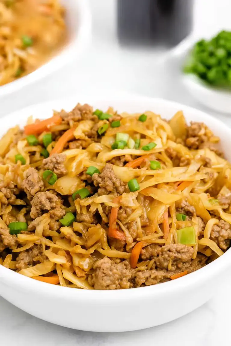 Egg Roll in a Bowl with ground beef, cabbage, and carrots garnished with green onions