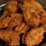 Ponderosa Steakhouse Chicken Wings stacked on a dark plate, perfectly golden and crispy.