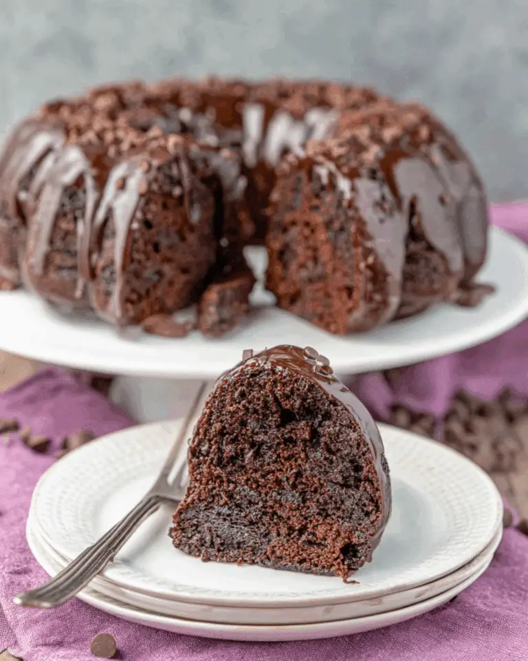 Chocolate Zucchini Bundt Cake with a slice served on a plate, showcasing its moist interior and chocolate glaze.