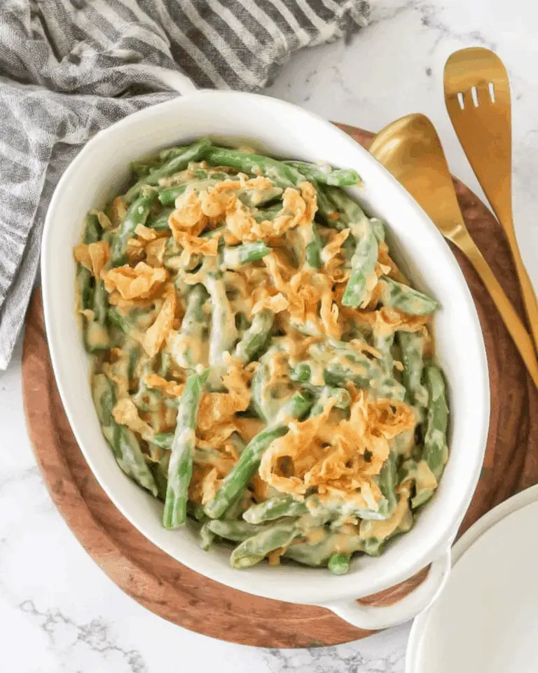Classic Campbell's Green Bean Casserole topped with crispy fried onions in a white baking dish.