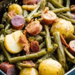Crockpot Kielbasa and Green Beans with baby potatoes and crispy bacon in a slow cooker.