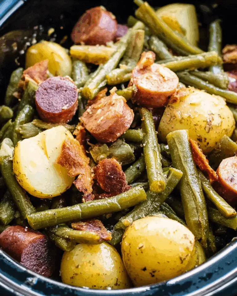 Crockpot Kielbasa and Green Beans with baby potatoes and crispy bacon in a slow cooker.