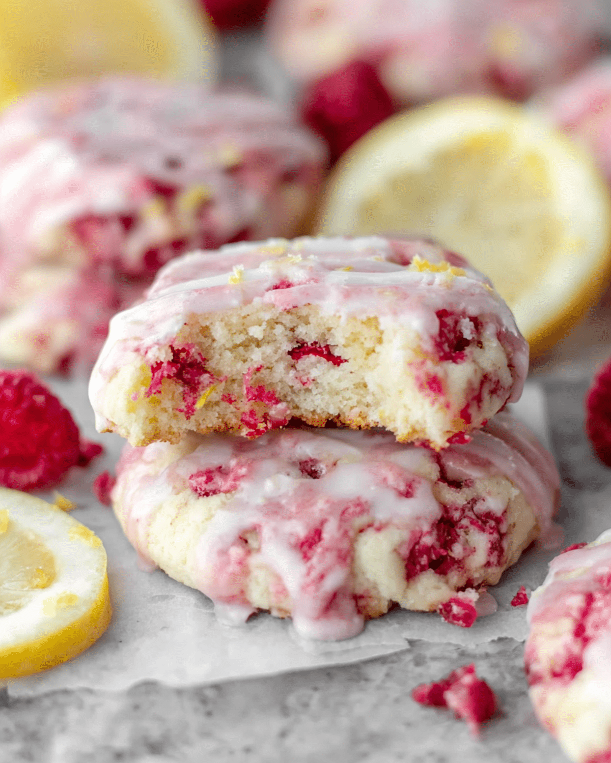Lemon Raspberry Cookies with a drizzle of glaze and visible raspberry and lemon zest pieces