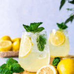 Refreshing Limoncello Spritz garnished with lemon slices and fresh mint in a clear glass.