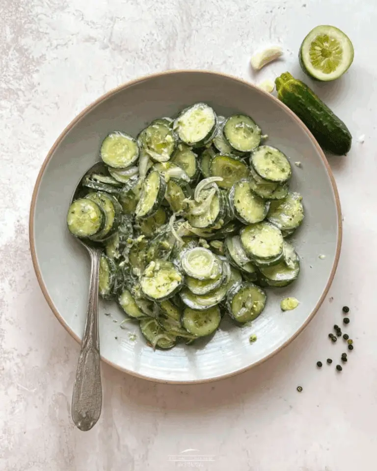 Bowl of ranch cucumber salad with sliced cucumbers, onions, and a creamy ranch dressing.