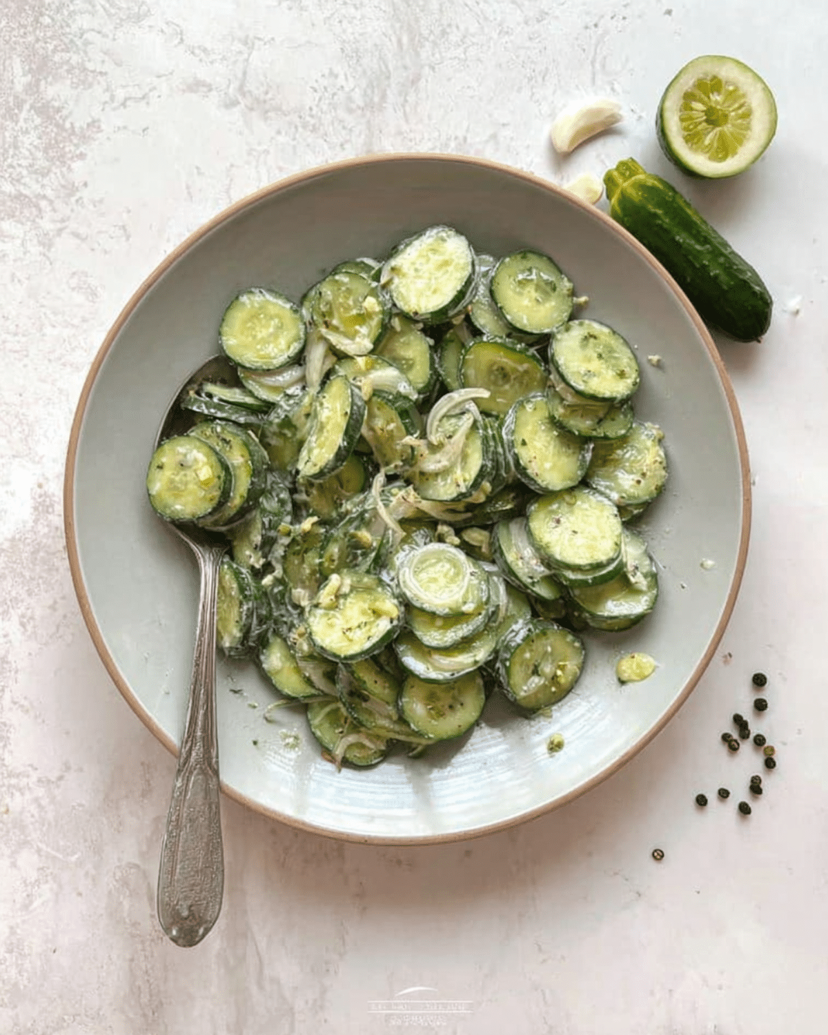 Bowl of ranch cucumber salad with sliced cucumbers, onions, and a creamy ranch dressing.