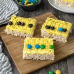 Ruler Rice Krispies treats topped with yellow frosting, black ruler lines, and colorful candy decorations.