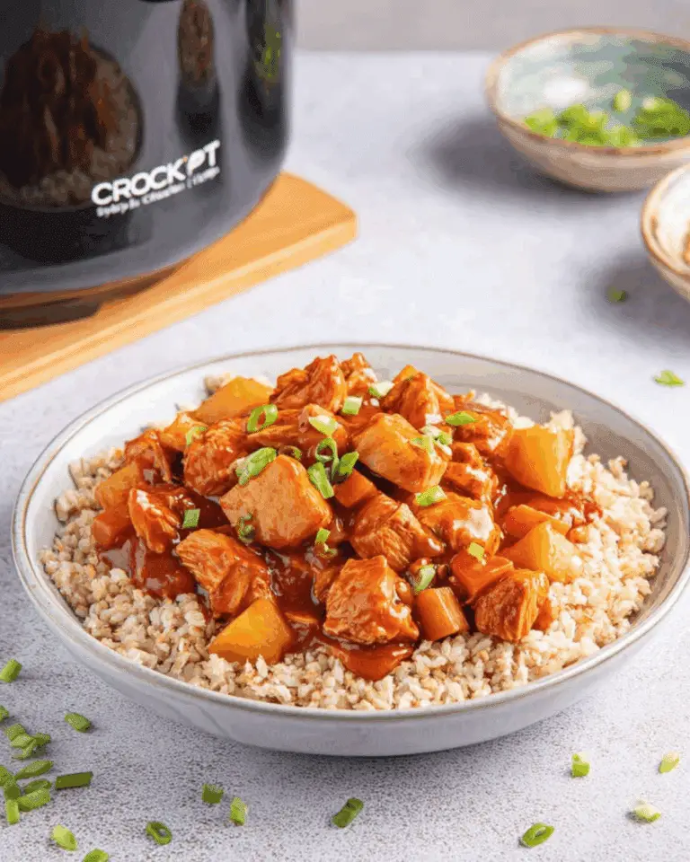 Sweet Hawaiian Crockpot Chicken served over brown rice and garnished with chopped green onions.