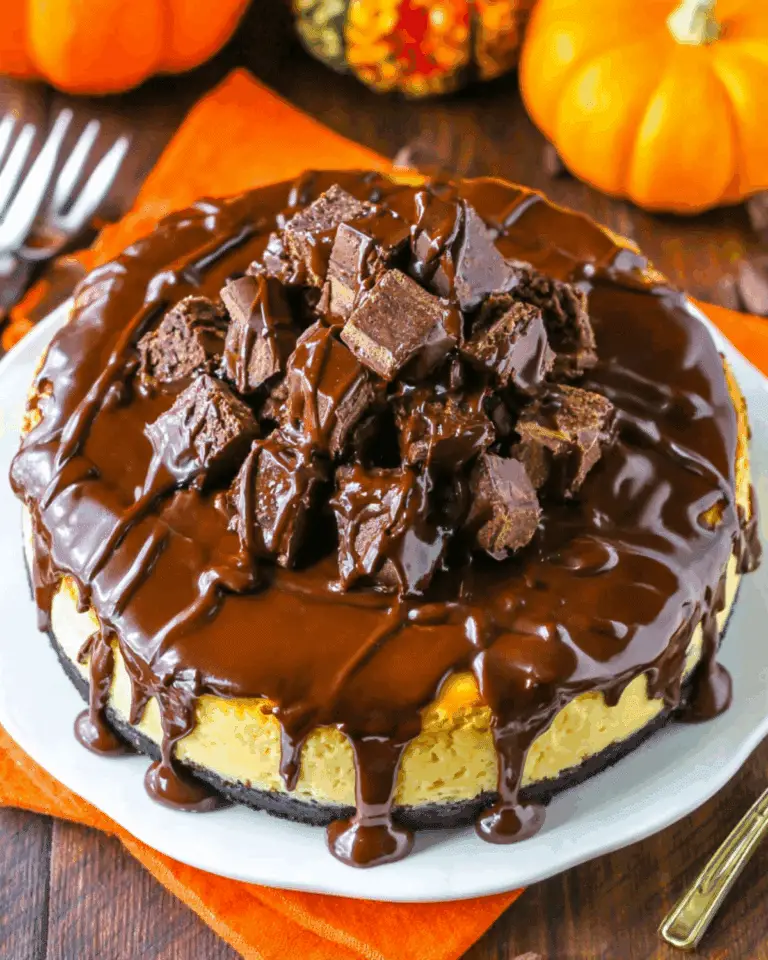 Chunkin chocolate pumpkin cheesecake topped with chunks of chocolate candy and draped in rich chocolate ganache.