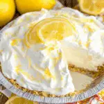 Creamy No bake Lemon Pie topped with whipped cream, lemon zest, and lemon slices in a graham cracker crust.