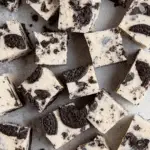 Close-up view of multiple pieces of Oreo Fudge with creamy white chocolate and chunks of Oreo cookies.