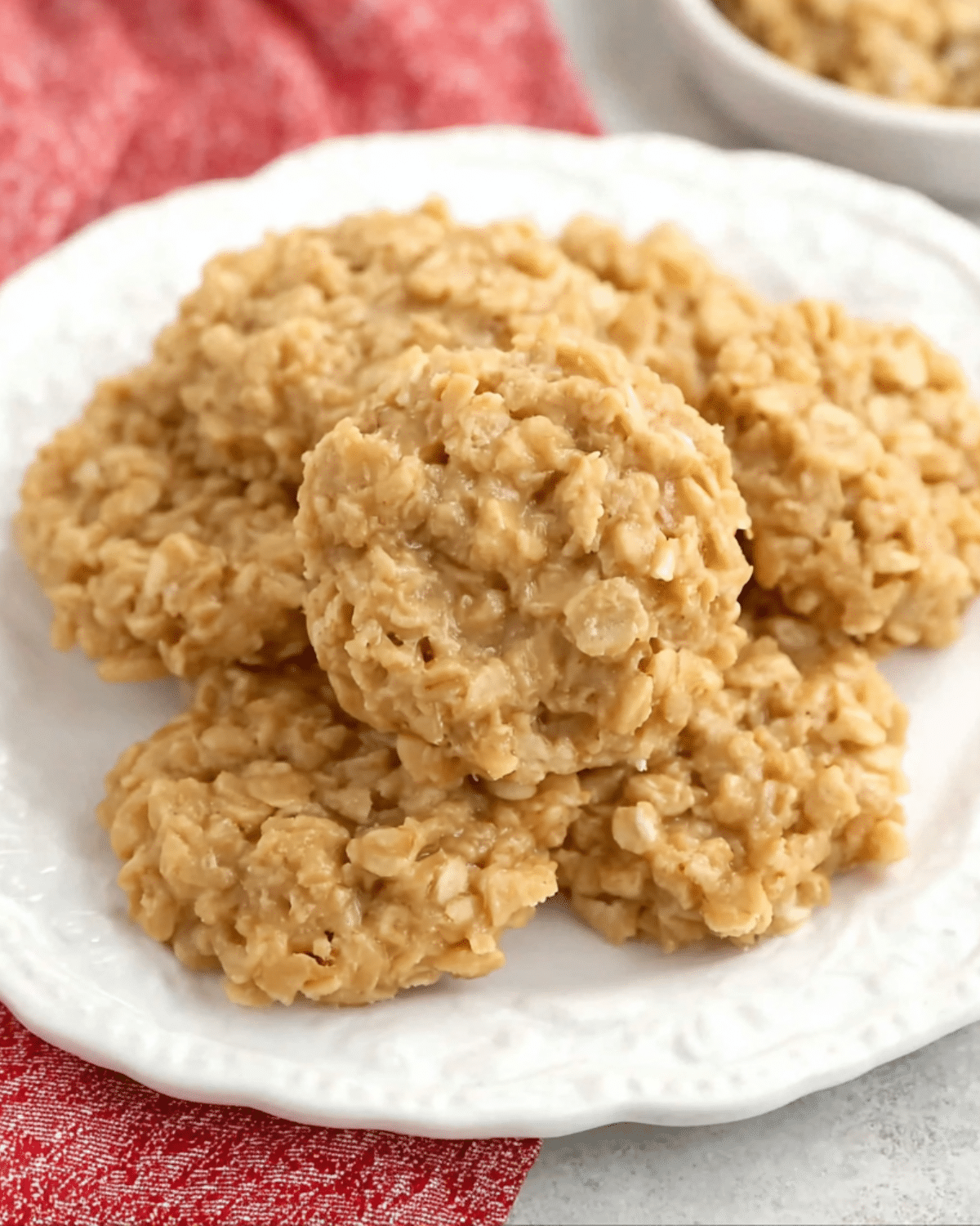 A plate of chewy No Bake Peanut Butter Cookies made with oats and creamy peanut butter, served on a white dish.