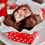 OLD-FASHIONED MARTHA WASHINGTON CANDY coated in chocolate with a colorful nut and cherry filling inside a red polka-dot wrapper.