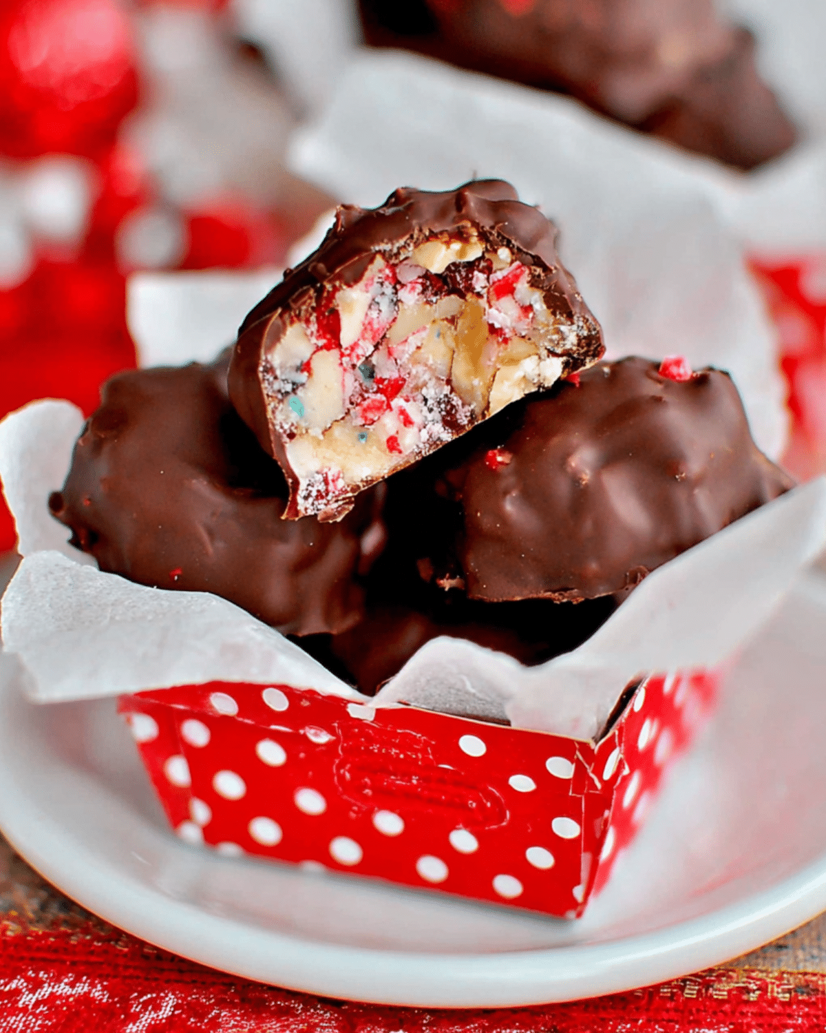 OLD-FASHIONED MARTHA WASHINGTON CANDY coated in chocolate with a colorful nut and cherry filling inside a red polka-dot wrapper.