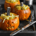 Mini carved pumpkins filled with cheesy macaroni, served as festive pumpkin jack ’n cheese bowls.