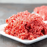 A plate of Raw Meat Rice Krispies, red-colored cereal treats resembling raw ground beef.