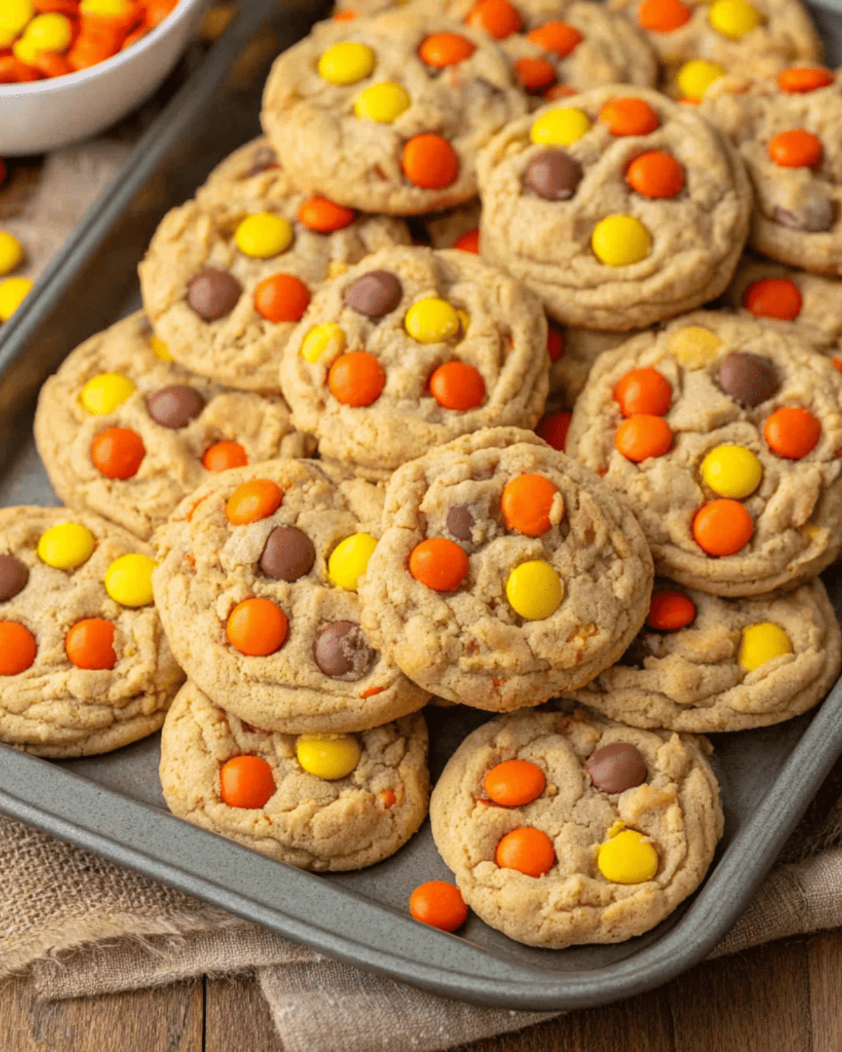 Tray filled with soft and chewy Reese's Pieces Cookies topped with colorful candy-coated peanut butter pieces.