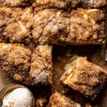 Top view of sliced easy cinnamon sugar apple cake with a scoop of vanilla ice cream.