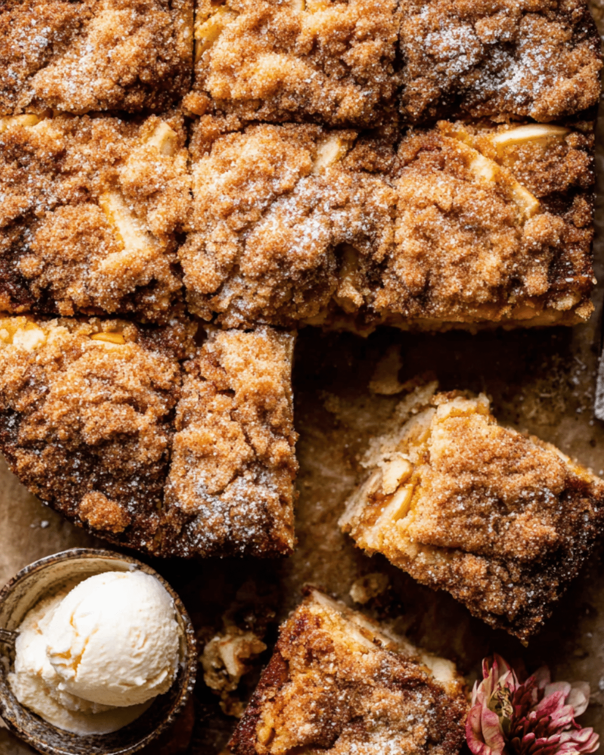 Top view of sliced easy cinnamon sugar apple cake with a scoop of vanilla ice cream.