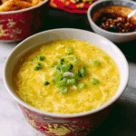 Bowl of restaurant-style egg drop soup topped with chopped green onions
