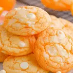 Stack of soft Creamsicle Cookies with white chocolate chips on a plate.